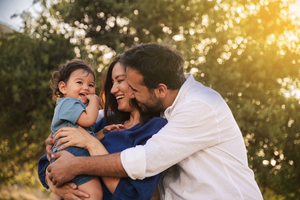 Familia feliz abrazándose al aire libre